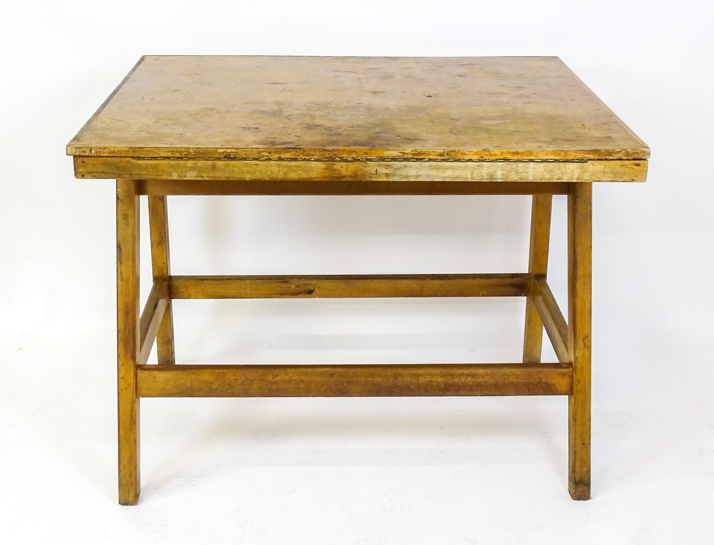 A mid / late 20thC artists desk with a hinged, adjustable top raised on tapering legs united by a - Image 10 of 11