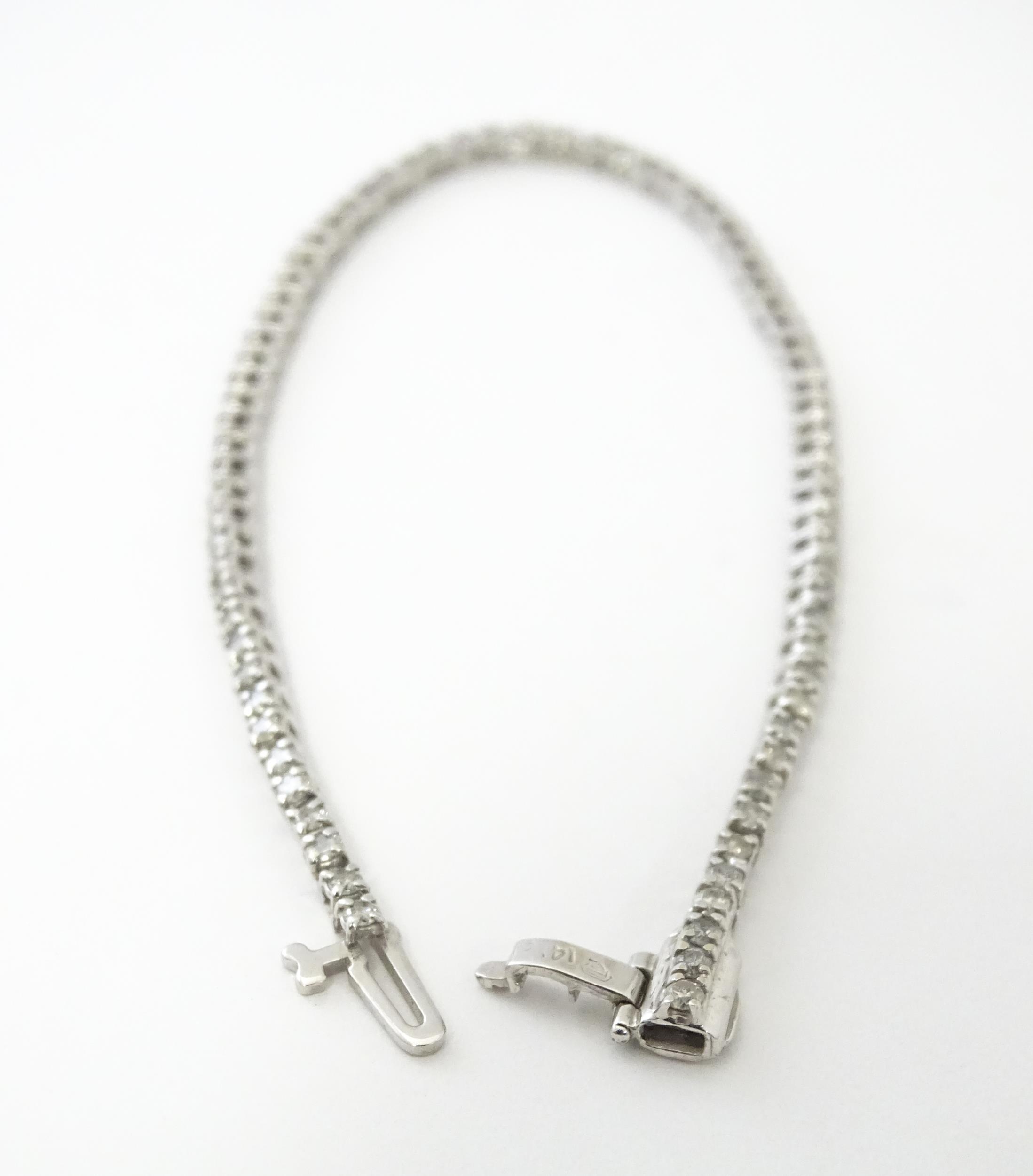 A 14ct white gold tennis bracelet set with diamonds. Approx 7 1/2" long Please Note - we do not make - Image 7 of 10
