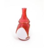 A small Bohemian style red and white glass bottle vase with gilt highlights. Approx. 3 3/4" high
