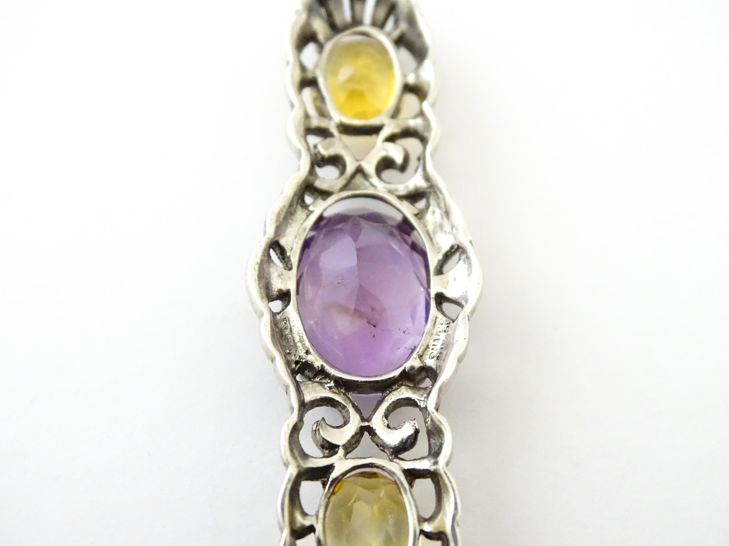 A silver brooch set with amethyst, citrine and marcasite. Approx 2 1./4" wide Please Note - we do - Image 2 of 8