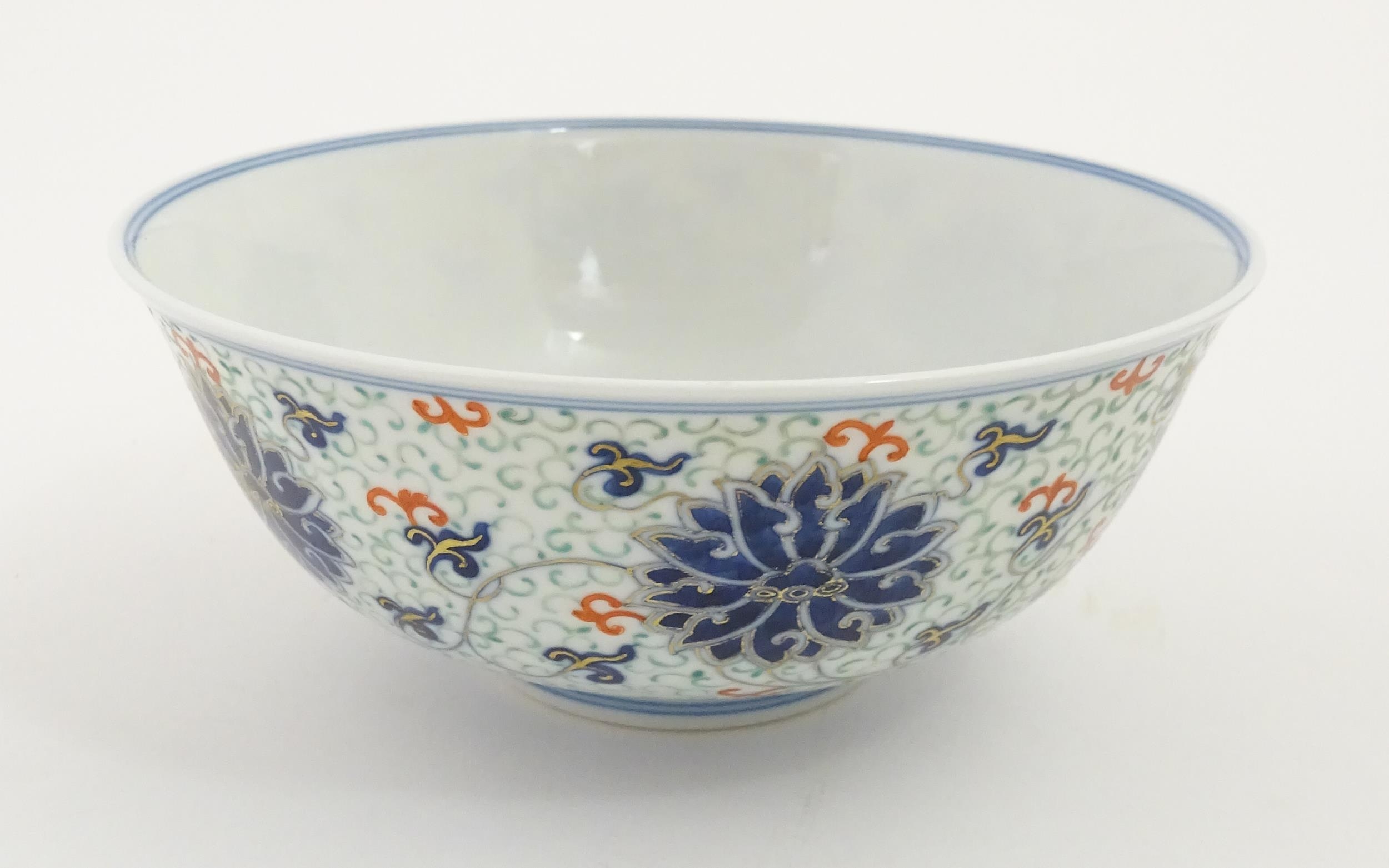 A Chinese bowl decorated with scrolling floral and foliate detail. Character marks under. Approx. 3" - Image 3 of 9
