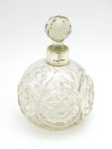 A Victorian cut glass scent / perfume bottle with silver mounts hallmarked Chester 1897, maker