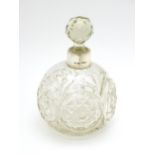 A Victorian cut glass scent / perfume bottle with silver mounts hallmarked Chester 1897, maker