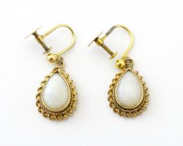 A pair of 9ct gold drop earrings set with opals. Approx 1" long Please Note - we do not make