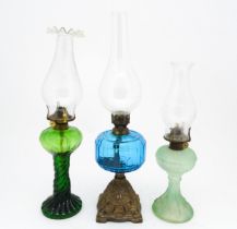 Three early 20thC oil lamps to include a French Art Nouveau example by Portieux Vallerysthal with