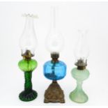 Three early 20thC oil lamps to include a French Art Nouveau example by Portieux Vallerysthal with