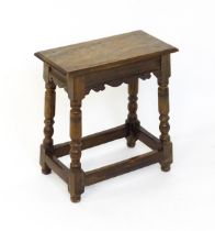 A 19thC walnut join stool of peg jointed construction, with a rectangular top above a moulded