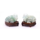 Two Chinese carved green fluorite models of recumbent buffalo, on wooden stands. Approx. 5" wide (2)