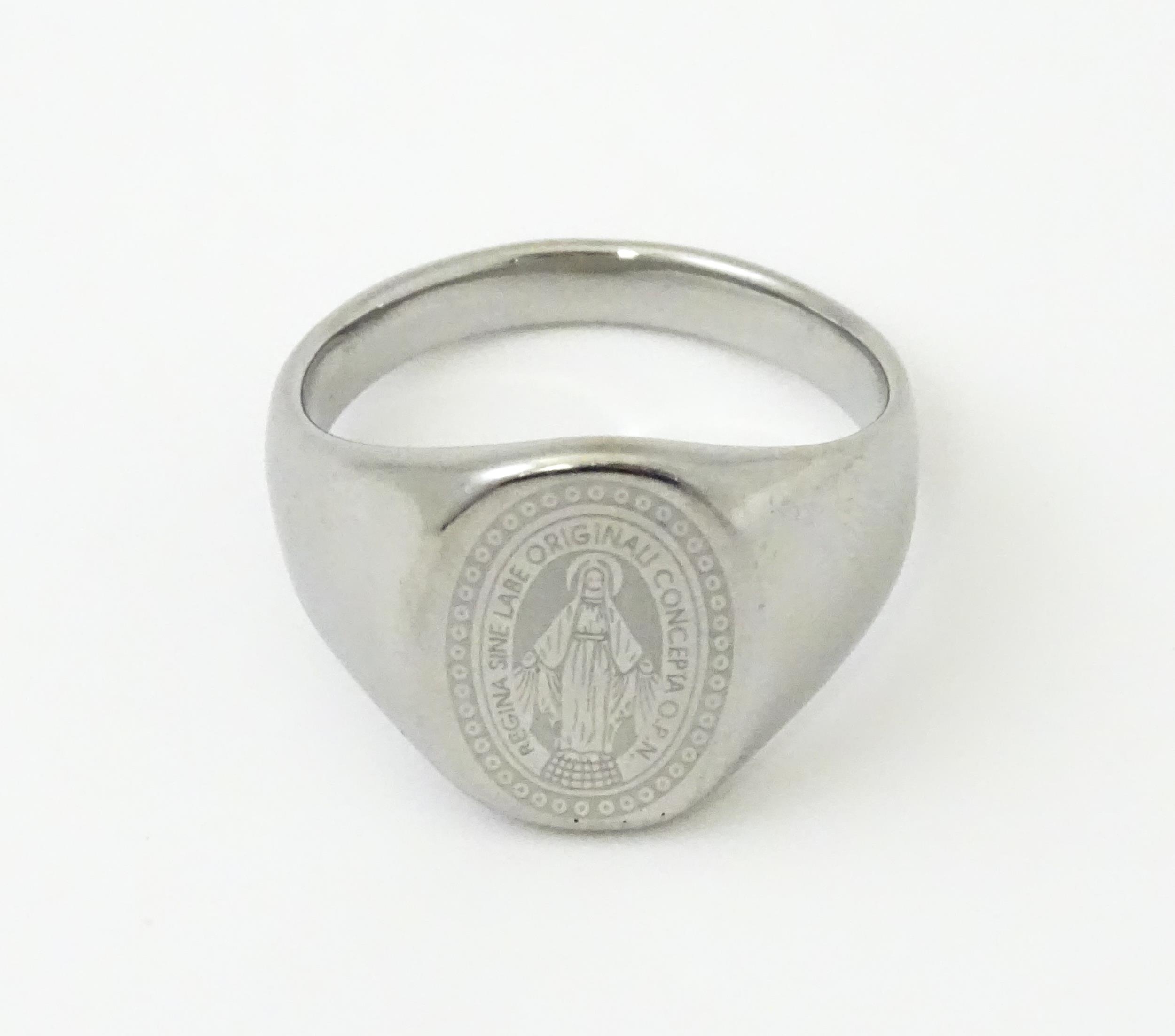 A Gentleman's white metal ring with engraved Christian symbolism depicting the Virgin Mary and