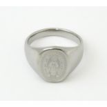 A Gentleman's white metal ring with engraved Christian symbolism depicting the Virgin Mary and