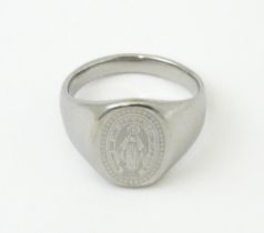 A Gentleman's white metal ring with engraved Christian symbolism depicting the Virgin Mary and