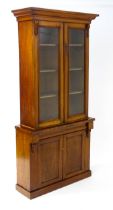 A Victorian mahogany chiffonier bookcase, the top having a moulded cornice above glazed doors