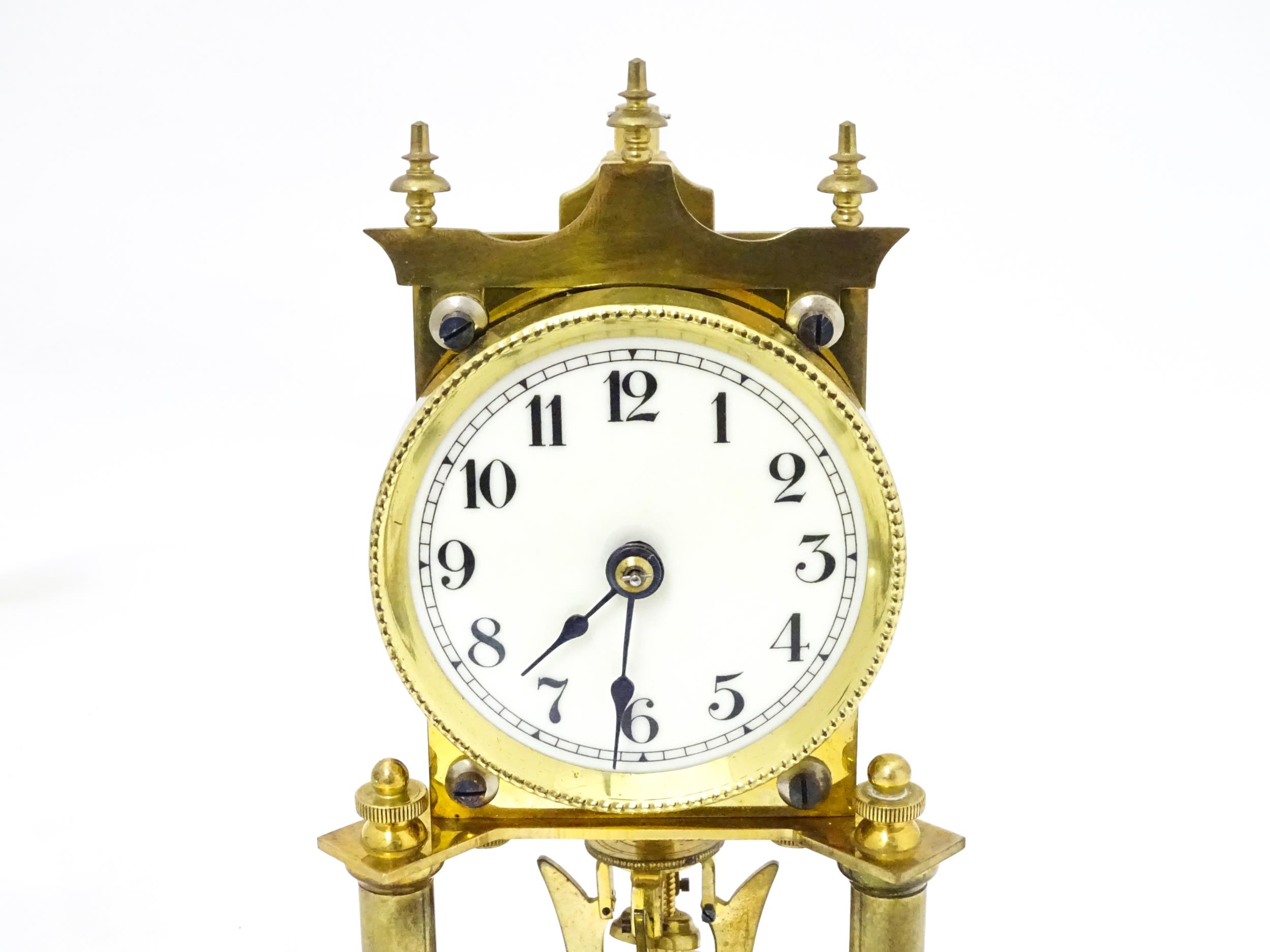 A 20thC anniversary / table clock with white enamel dial and Roman numerals. Under glass dome - Image 5 of 12