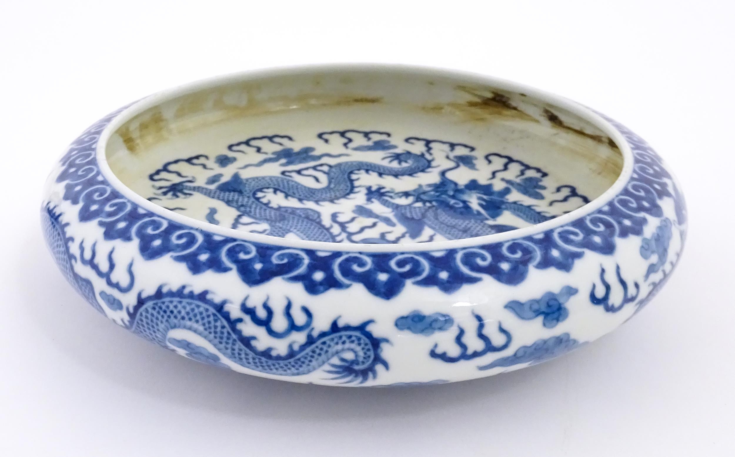 A Chinese blue and white dish decorated with dragons amidst clouds. Character marks under. Approx. - Image 4 of 8