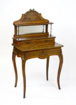 A 19thC mahogany Bonheur du jour with a shaped and mirrored upstand having marquetry decoration