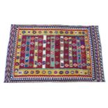 Carpet / Rug : A South West Persian qashgai kilim rug with banded geometric motifs and borders.