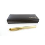 A cased Sheaffer 'Targa 1009' fountain pen with gold plated chequered barrel and cap, 14ct gold nib,