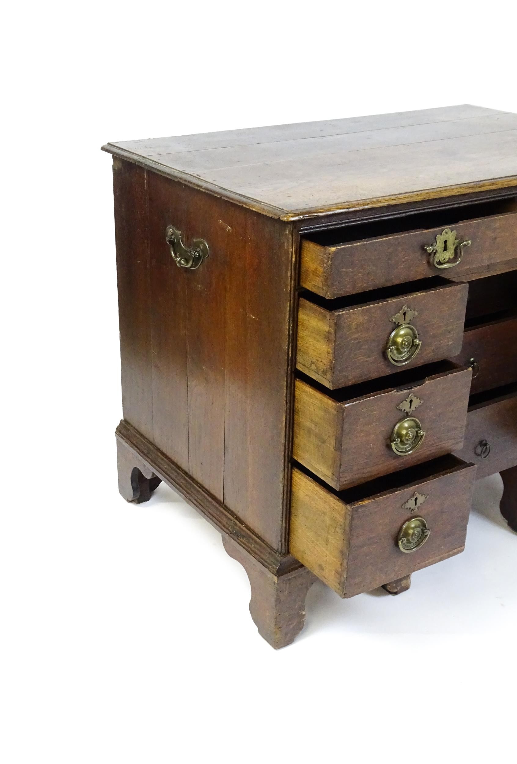 An early / mid 18thC oak kneehole desk with a moulded top above two short drawers and two banks of - Image 4 of 10