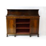 A 19thC rosewood bookcase with a moulded shelf raised on two scrolled brackets, the base having