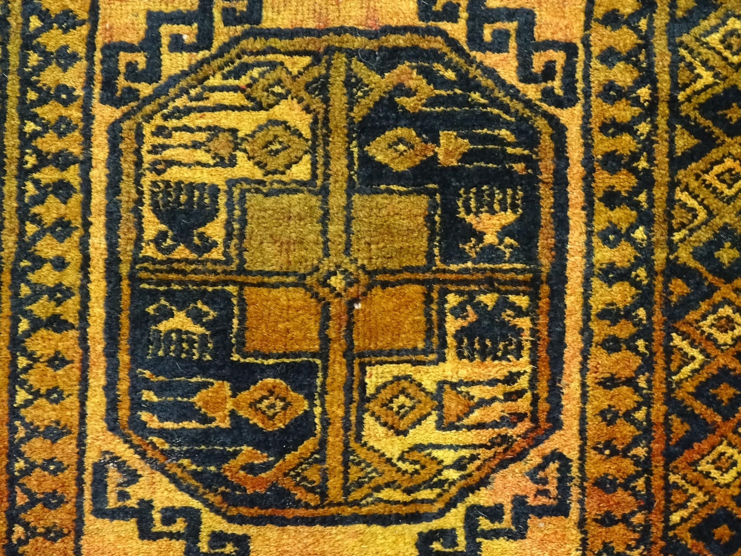 Carpet / Rug: An ochre ground rug decorated with centre vignettes with geometric motifs, further - Image 5 of 6