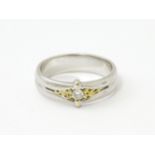 A 9ct white gold ring set with central diamond and gilt detail. Ring size approx. N Please Note - we