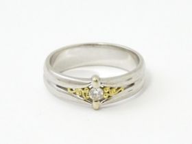 A 9ct white gold ring set with central diamond and gilt detail. Ring size approx. N Please Note - we