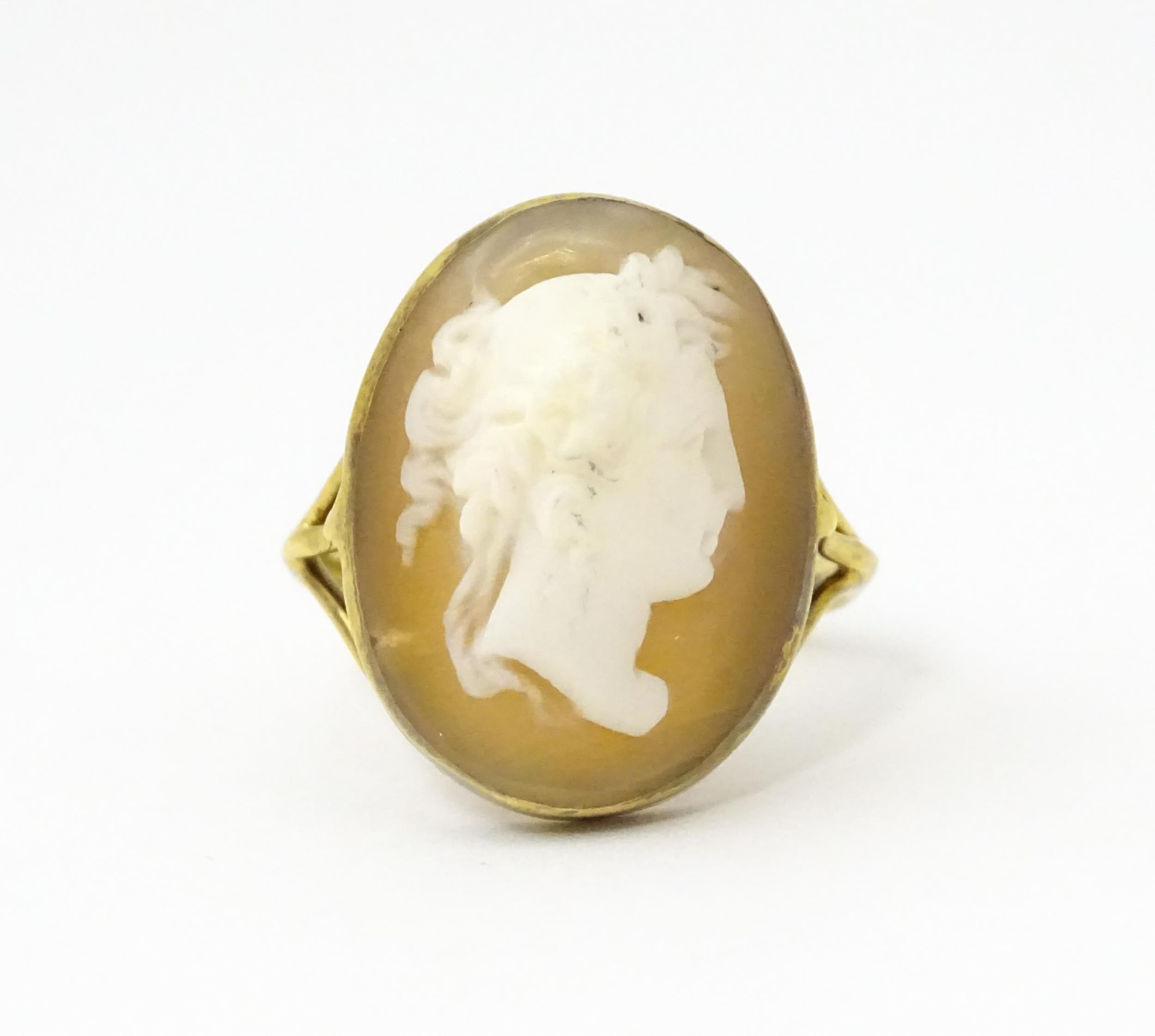 A 9ct gold ring set with classical cameo, the cameo approx 3/4" long Ring size approx. O Please Note