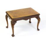 A mid / late 20thC coffee table with a burr walnut veneered top, with an egg and dart moulded edge