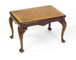 A mid / late 20thC coffee table with a burr walnut veneered top, with an egg and dart moulded edge