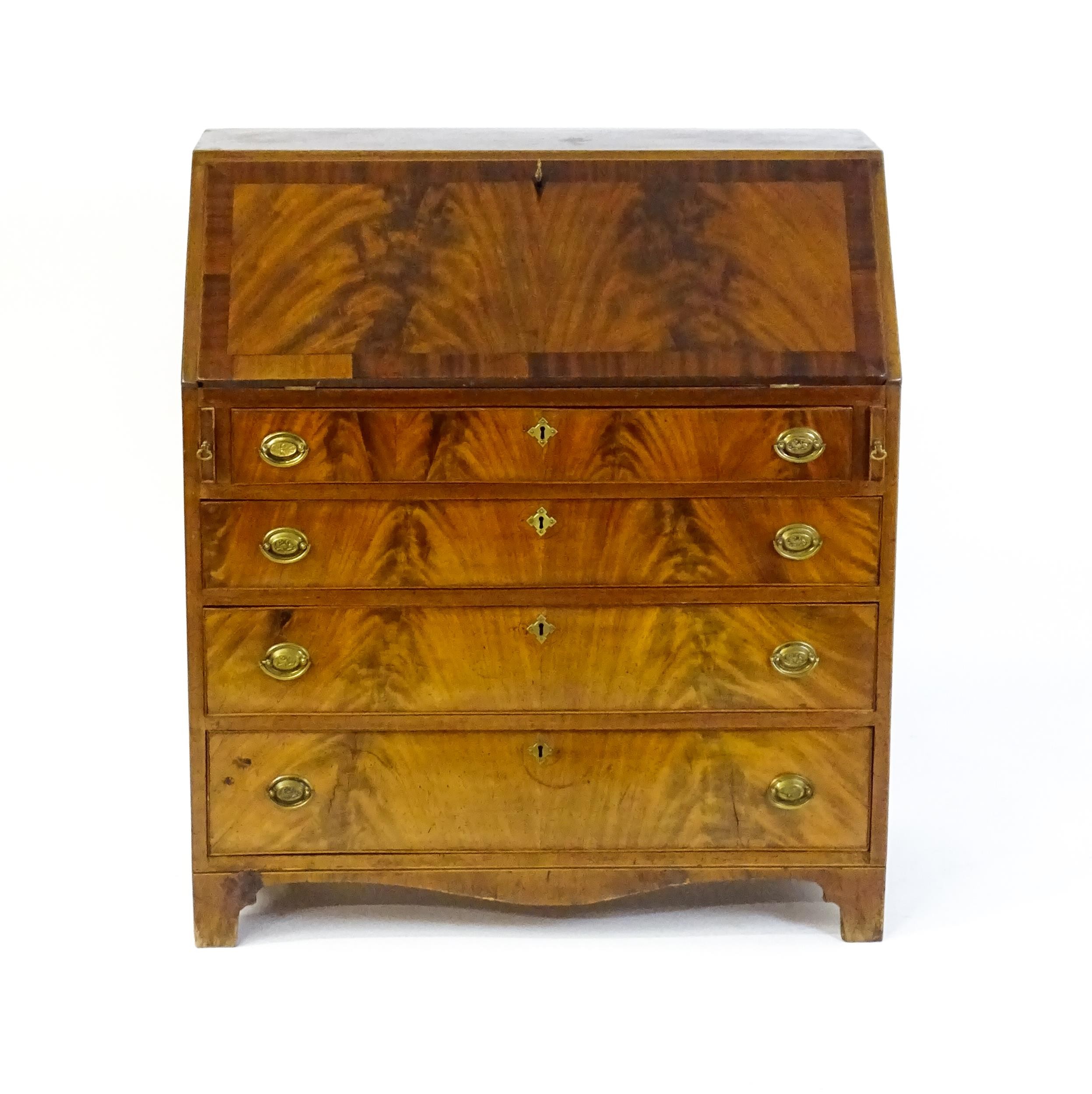 An early 19thC mahogany bureau with a fall front above four long graduated drawers with brass back - Image 4 of 6