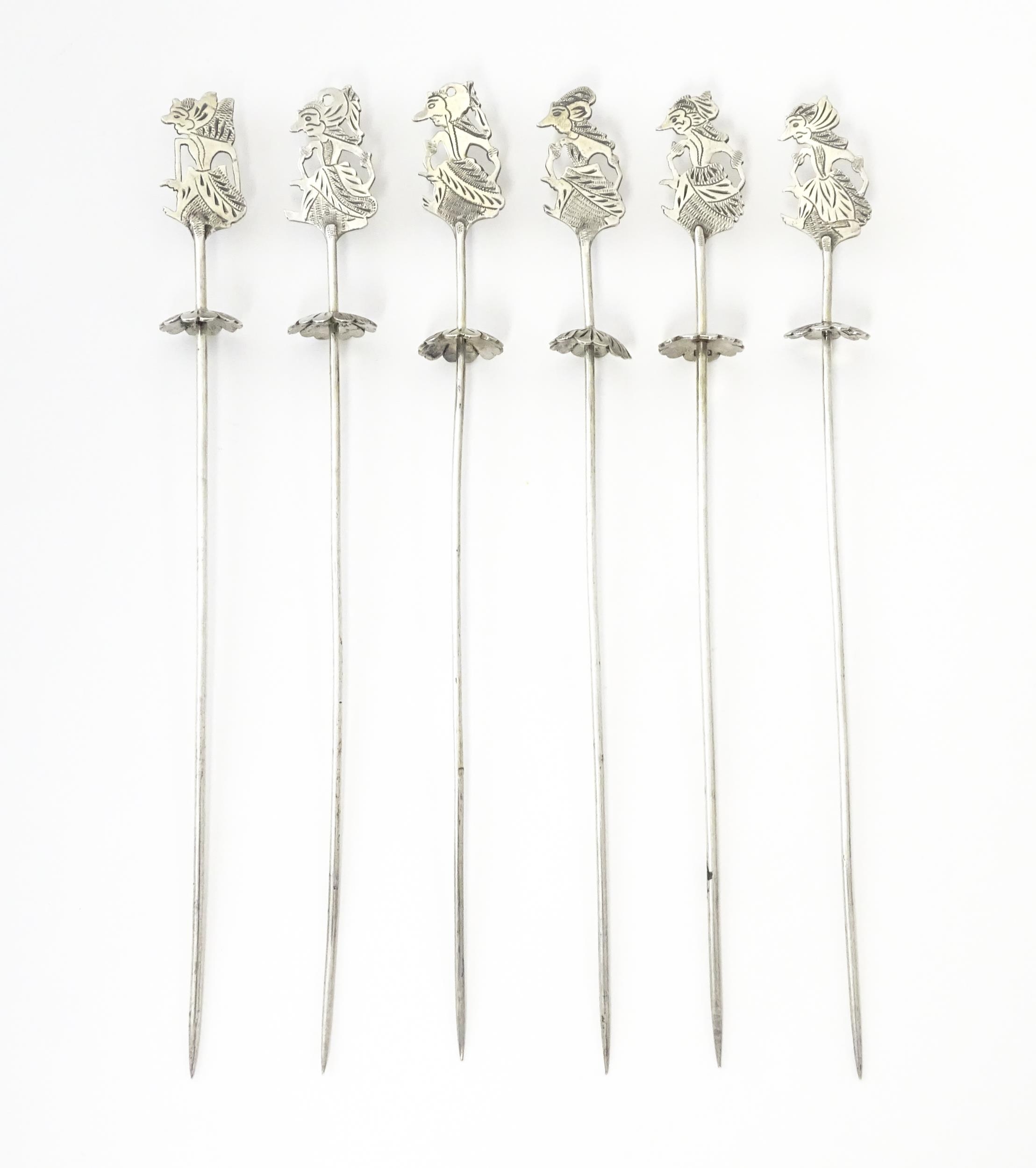 A set of Continental .800 silver skewers / long cocktail sticks with figural finials. Approx 7" long