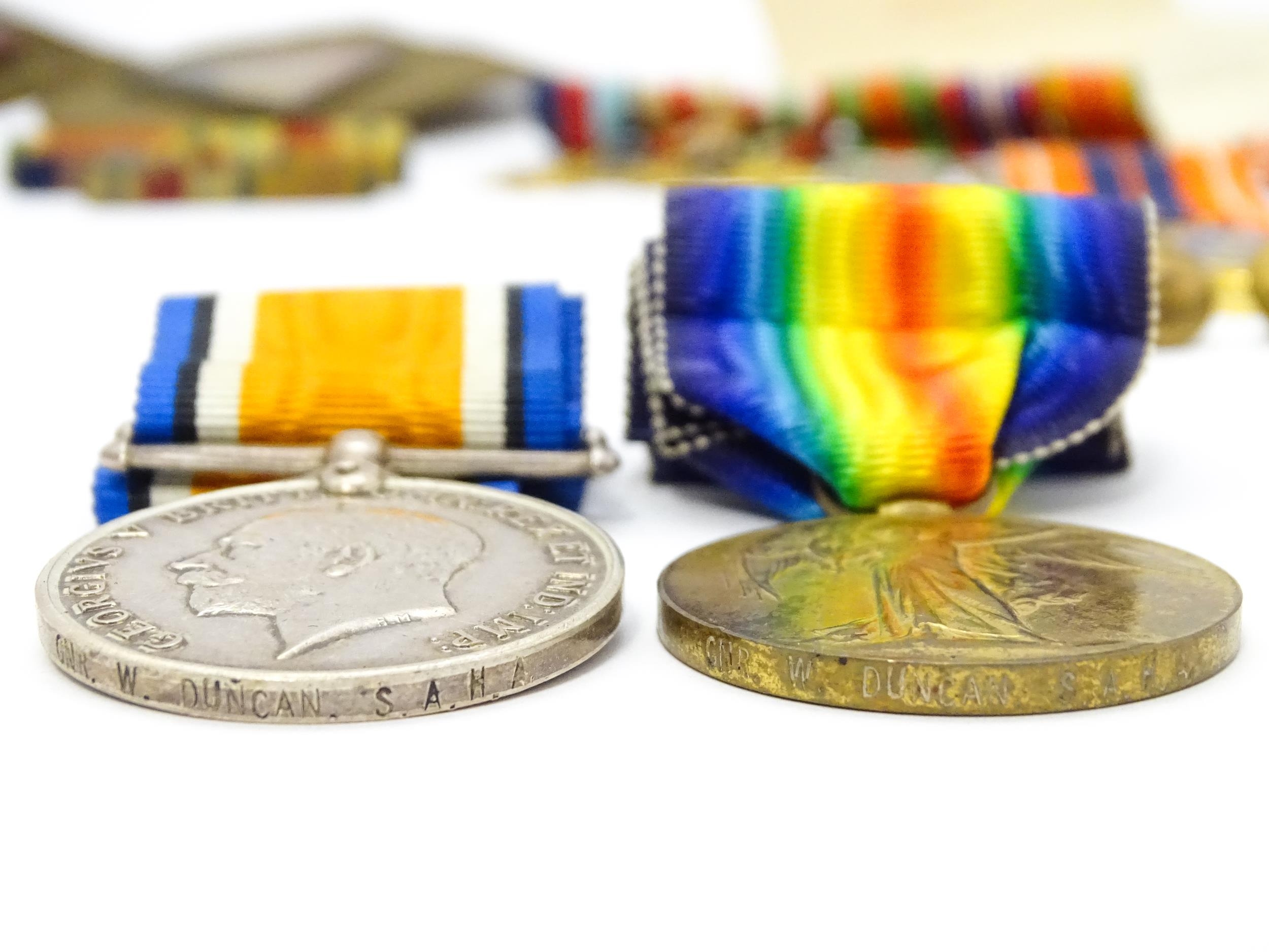 Militaria : a quantity of 20thC medals and insignia, comprising two WWI campaign medals to Gnr. W. - Image 13 of 16