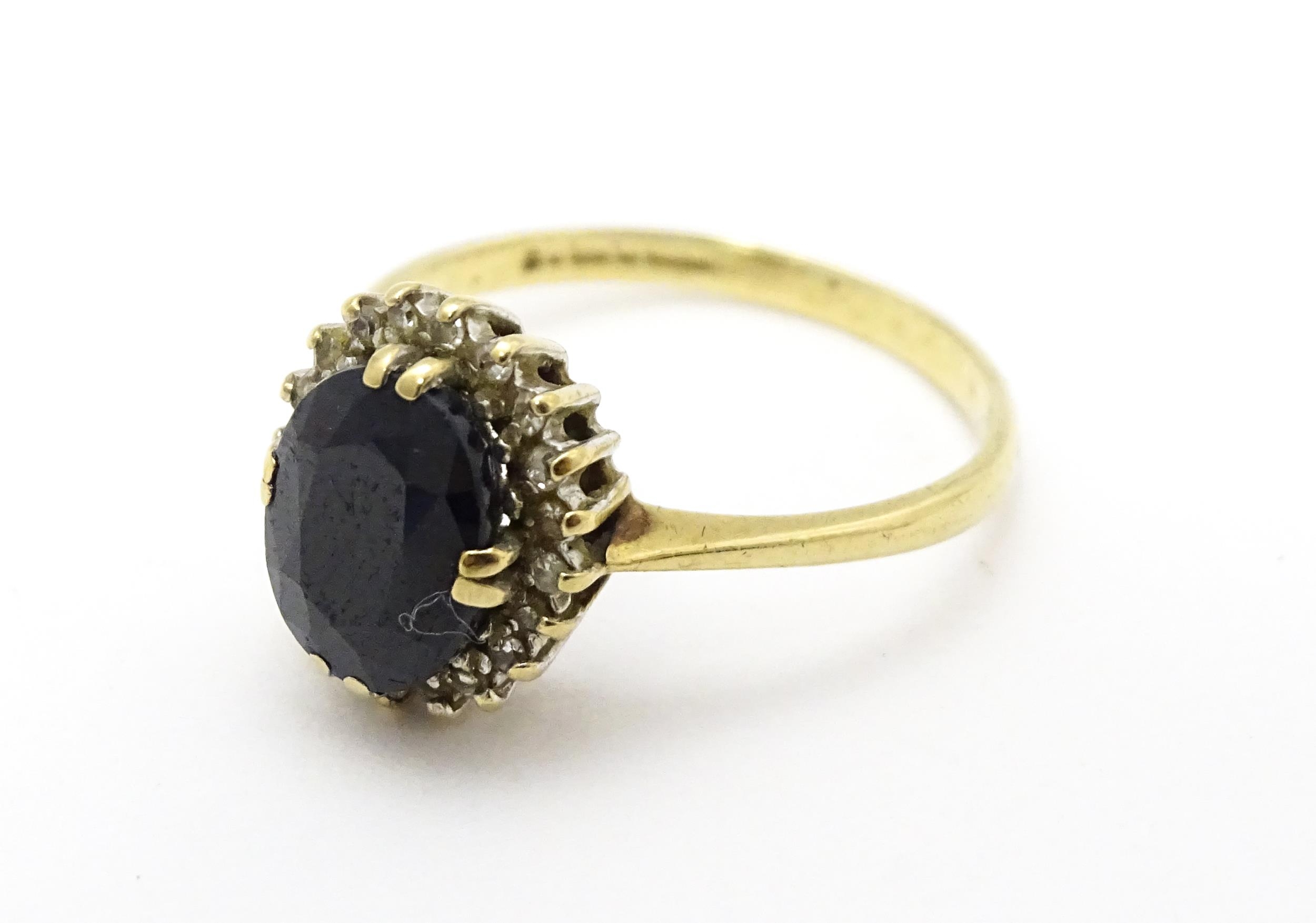 A 9ct gold ring set with central sapphire bordered by diamonds. Ring size approx. P Please Note - we - Image 4 of 6