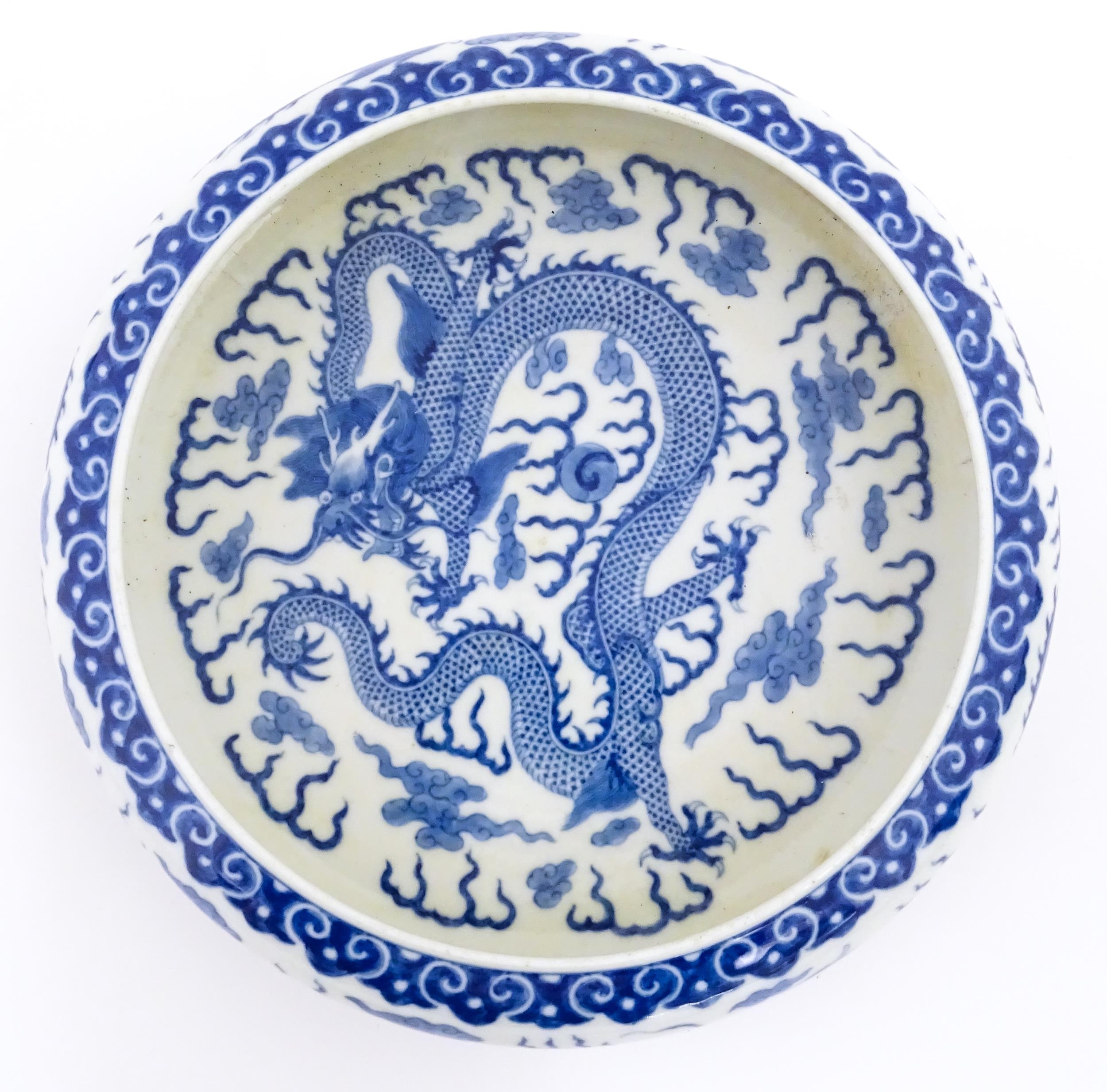 A Chinese blue and white dish decorated with dragons amidst clouds. Character marks under. Approx. - Image 7 of 8