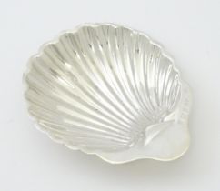 A silver butter dish of scallop shell form hallmarked Birmingham 1902, maker William Aitken. Approx.