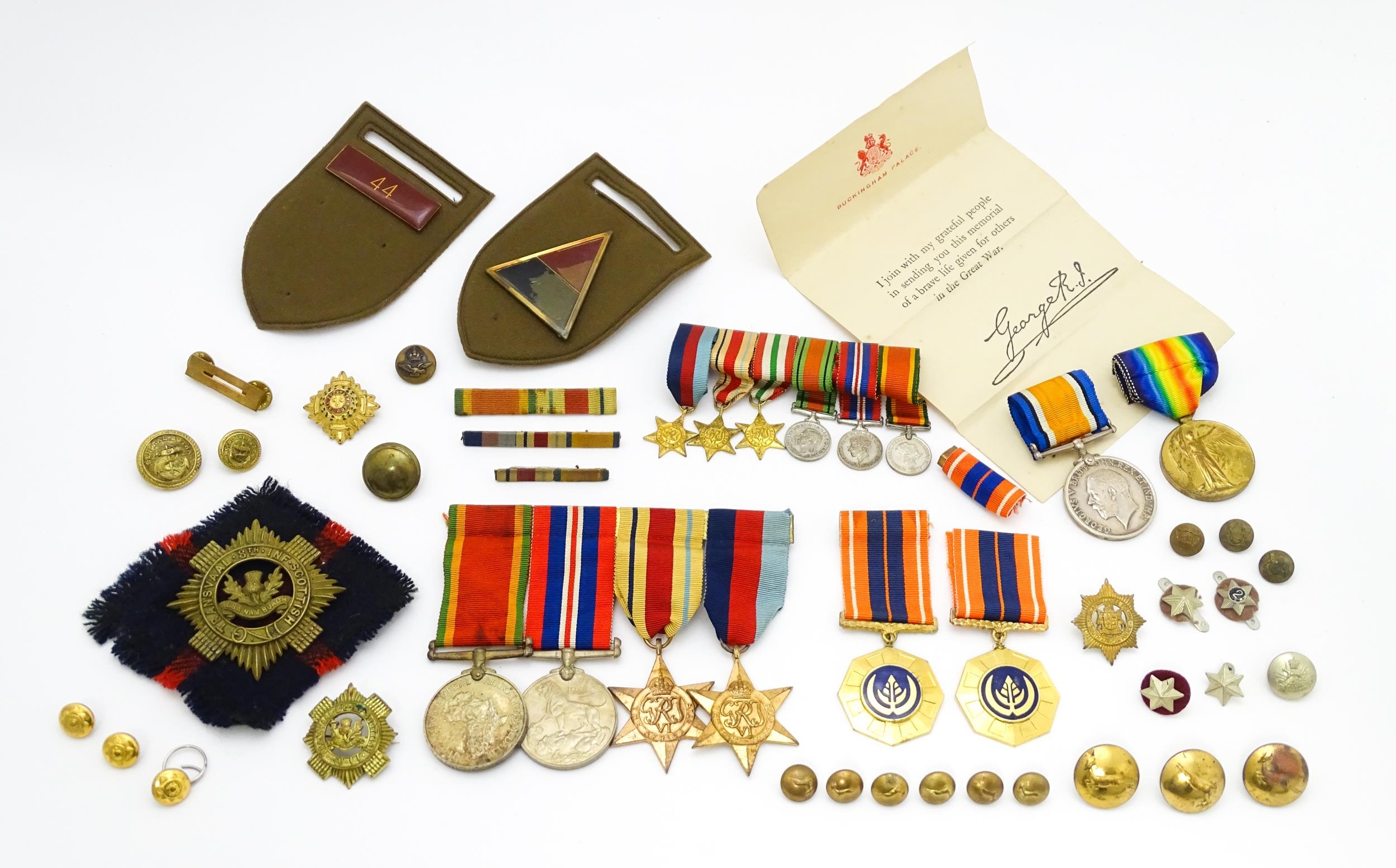 Militaria : a quantity of 20thC medals and insignia, comprising two WWI campaign medals to Gnr. W.
