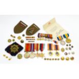 Militaria : a quantity of 20thC medals and insignia, comprising two WWI campaign medals to Gnr. W.