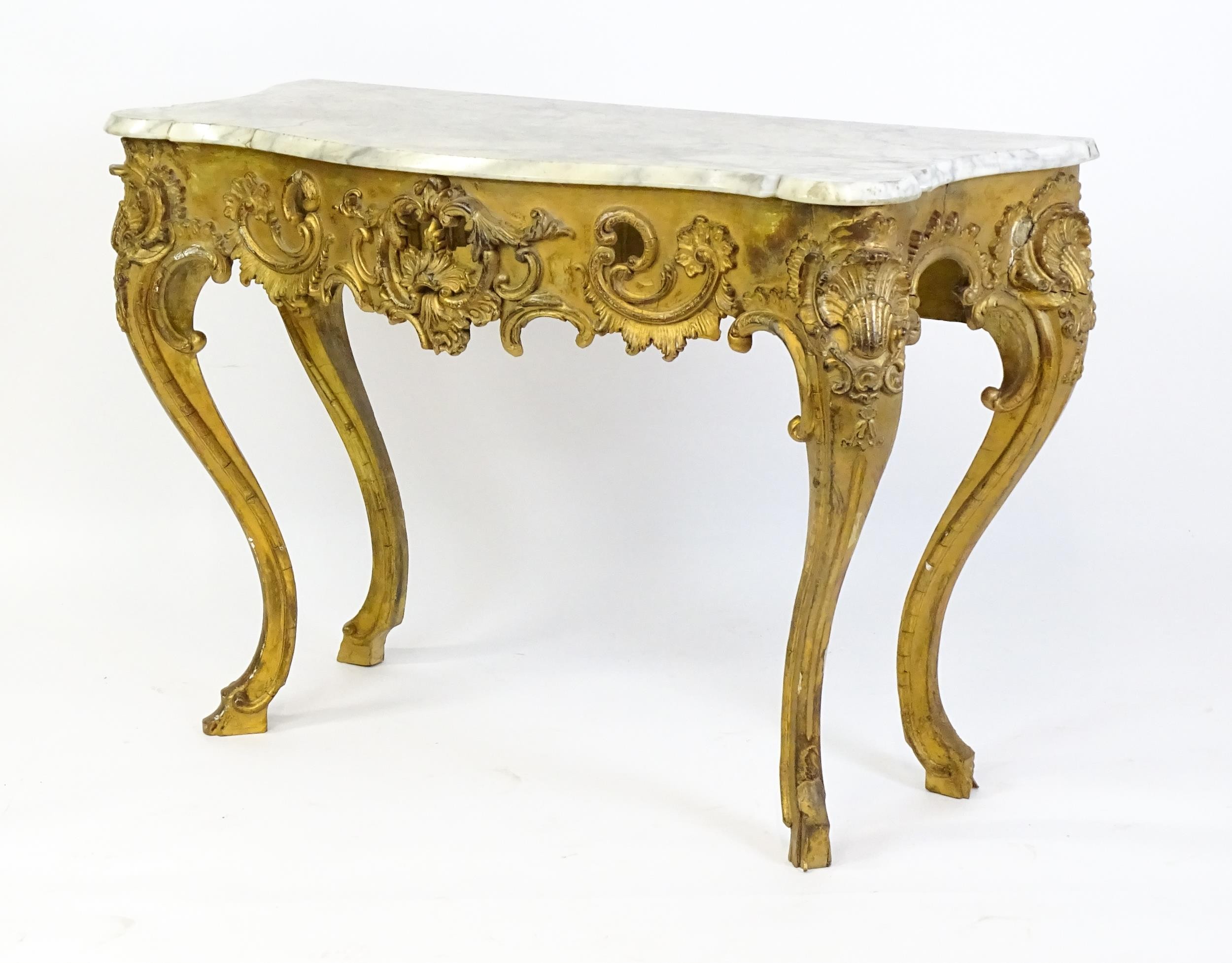 A 19thC marble topped table with a gesso and giltwood moulded base, decorated with shells, - Image 5 of 8