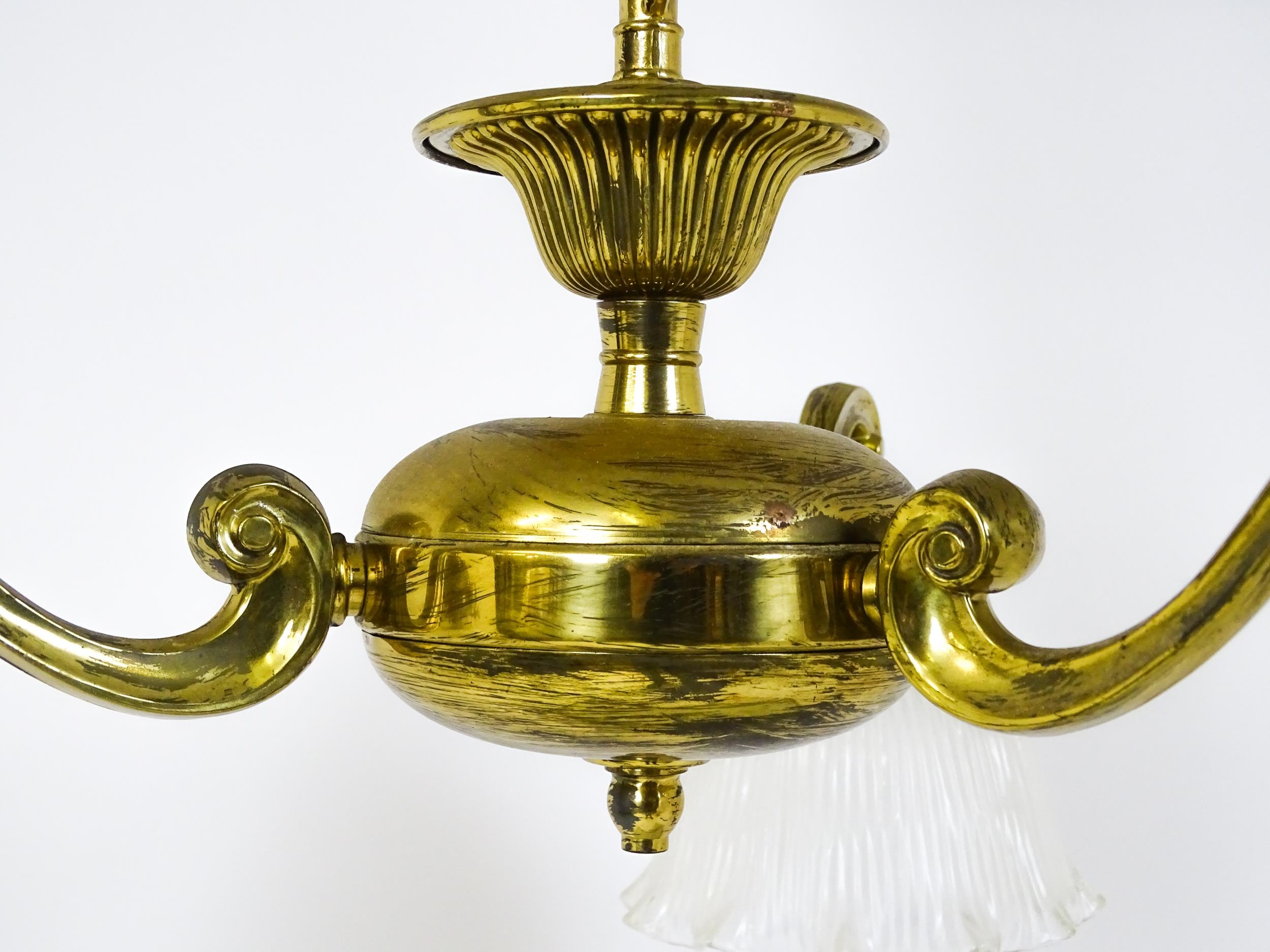 A pair of brass pendant lights having three scrolling branches with three holophane shades. - Image 4 of 16