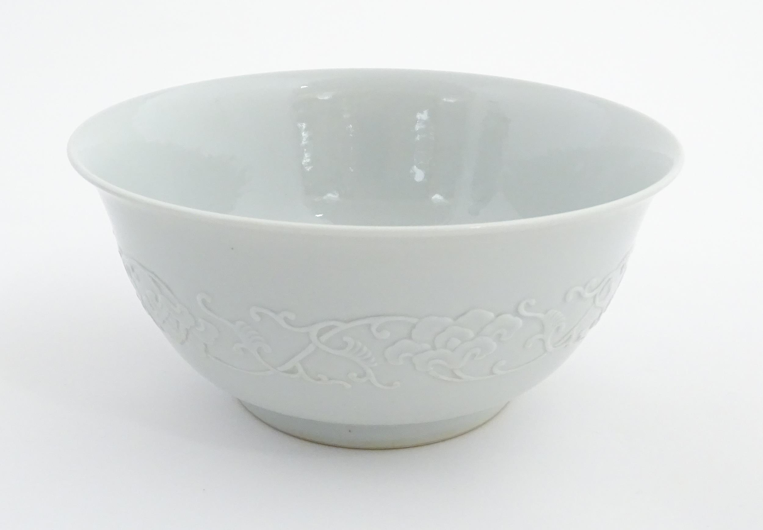 A Chinese bowl with banded foliate decoration to exterior and hand painted peached to interior.