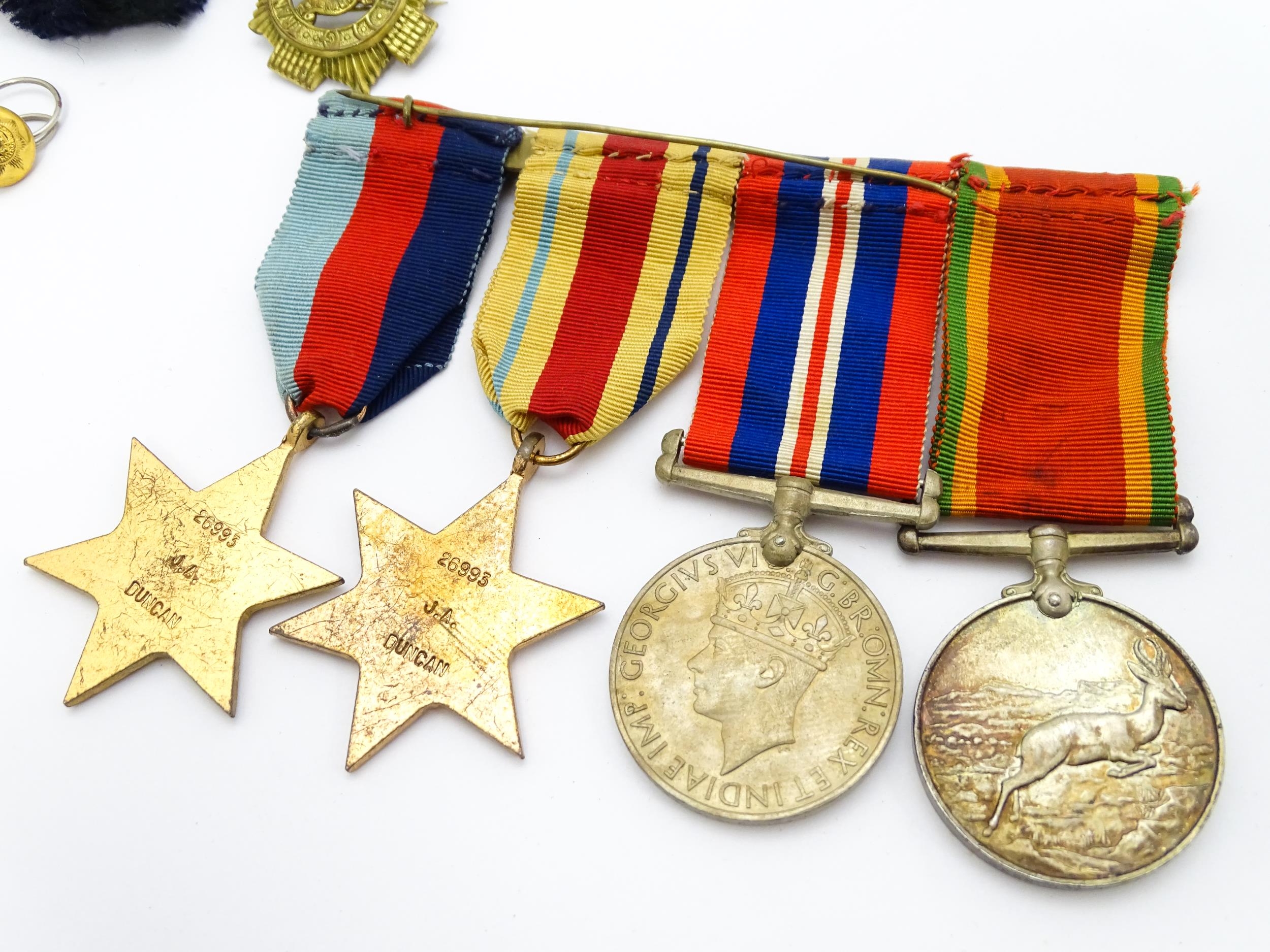 Militaria : a quantity of 20thC medals and insignia, comprising two WWI campaign medals to Gnr. W. - Image 12 of 16