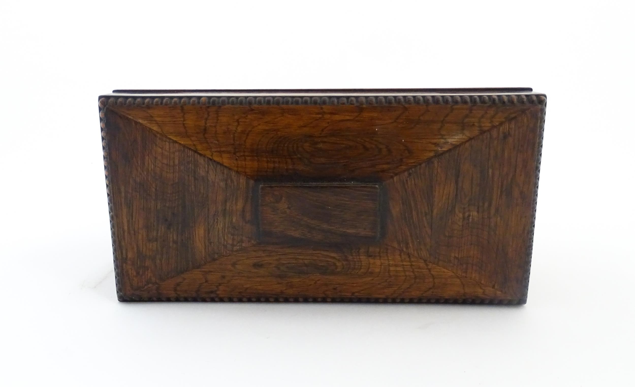 A 19thC rosewood tea caddy of sarcophagus form with four squat bun feet. The interior with two - Image 6 of 15