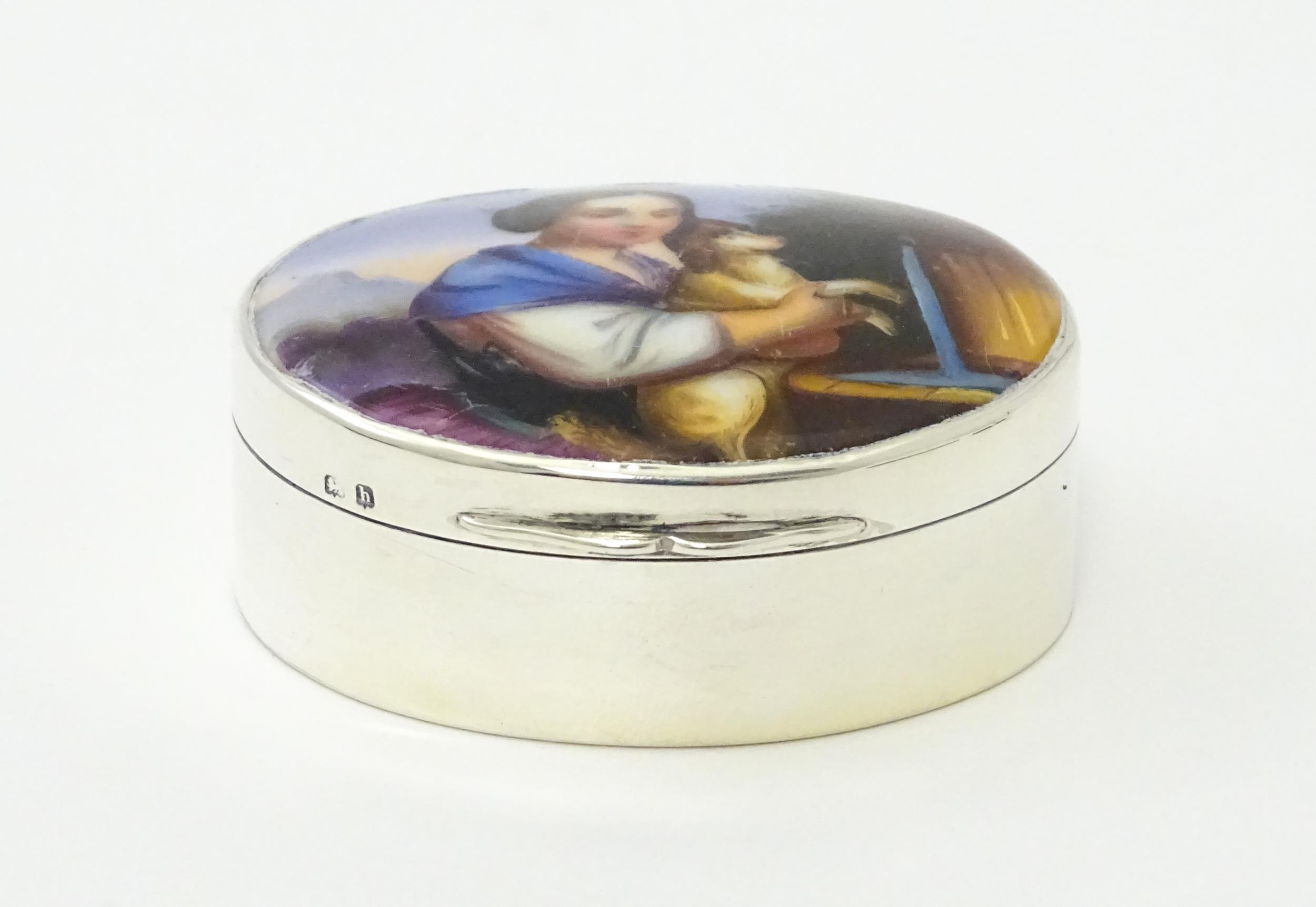 A silver pill box with gilded interior and ceramic cabochon to lid depicting a young girl holding - Image 3 of 9