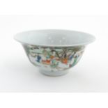 A Chinese famille verte bowl decorated with figures harvesting grain, the centre with a figure