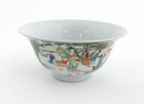 A Chinese famille verte bowl decorated with figures harvesting grain, the centre with a figure