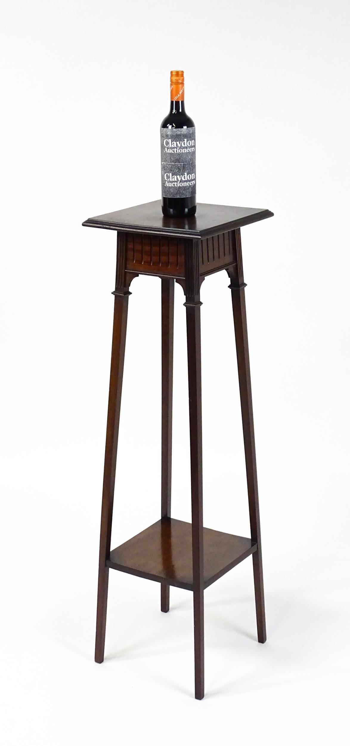An early / mid 20thC mahogany jardinière stand with a moulded top above a fluted frieze raised on - Image 2 of 7