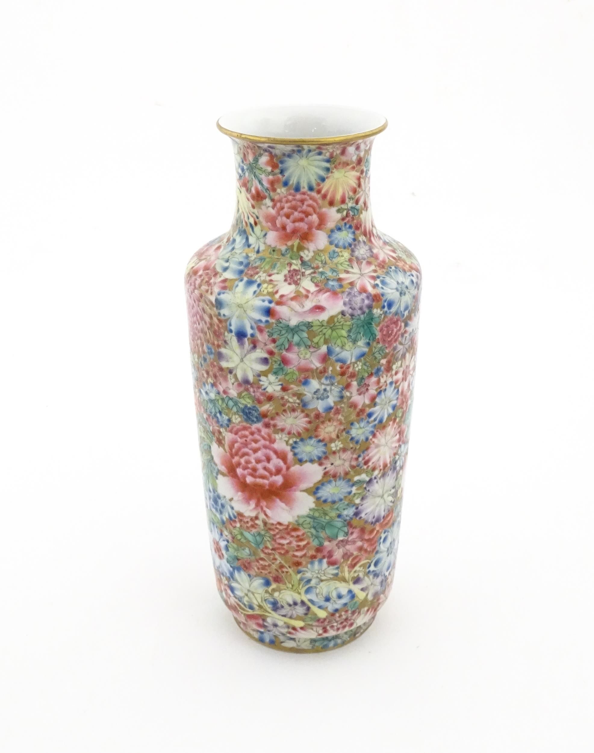 A Chinese famille rose vase decorated with a profusion of flowers. Character marks under. Approx. 10 - Image 4 of 6