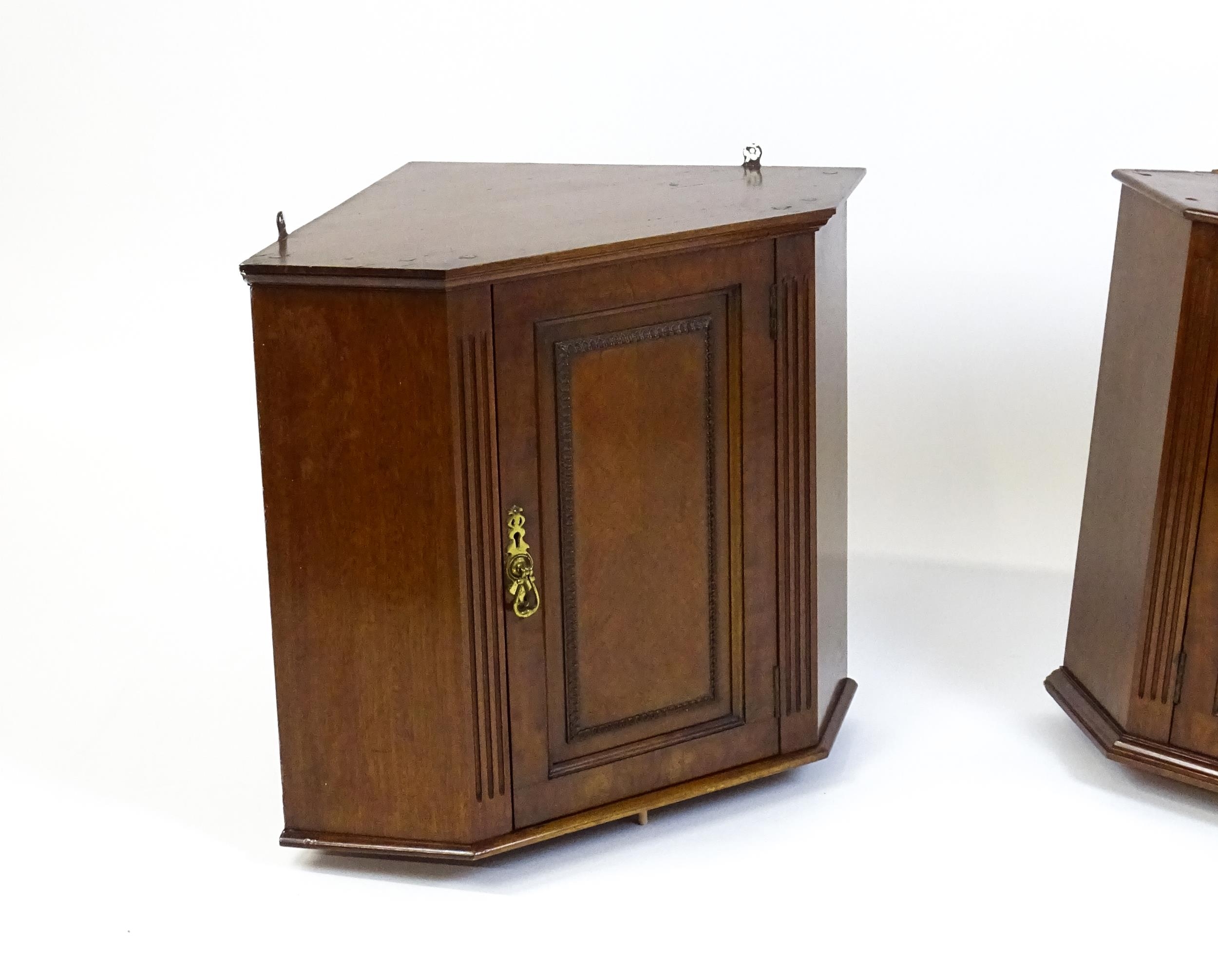 A pair of mid 20thC walnut corner cabinets. Bearing labels to back panels. 21 1/2 high x 26" wide - Image 4 of 7