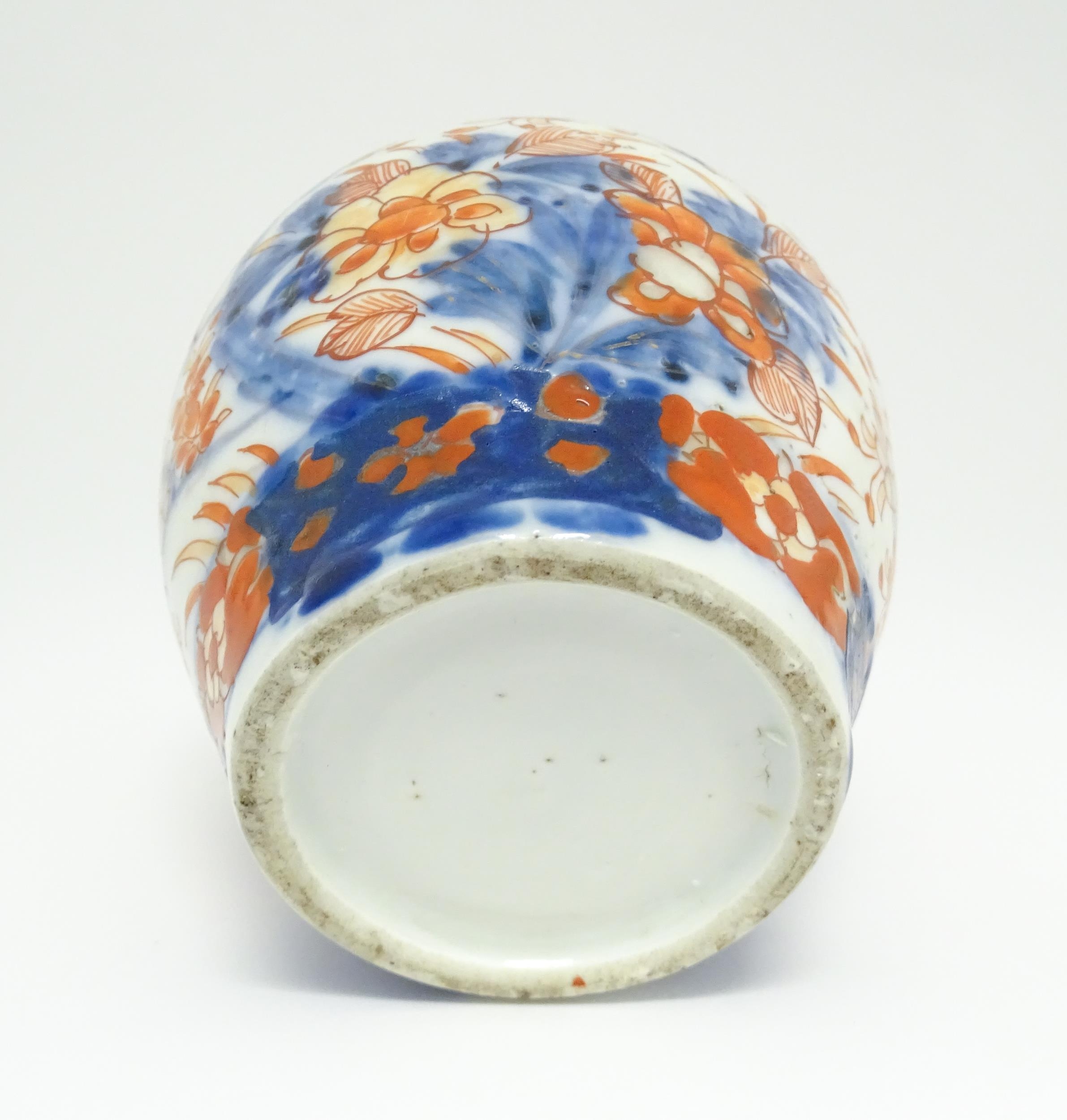 An Oriental ginger jar decorated in the Imari palette with flowers and foliage. Approx. 7 1/2" - Image 2 of 7