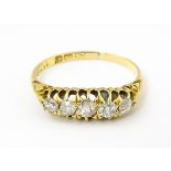 An 18ct gold ring set with five diamonds. Ring size approx. L Please Note - we do not make reference